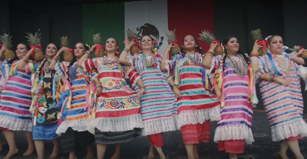 Women dance on a stage.